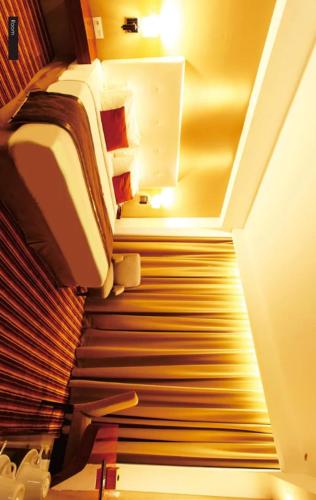 a room with a staircase leading to a room with a bed and astairsuggest at Hotel Holitel in Parit