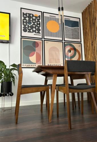 a dining room with a table and a chair at Metro Trocka Apartment in Warsaw