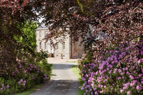 a garden of flowers in front of a building at Elrick Estate - Elrick House in Newmachar