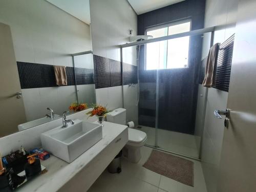 a bathroom with a sink and a toilet and a shower at Mol Residence in Esmeraldas