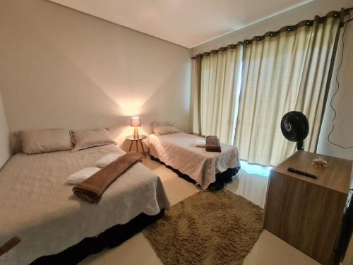 a bedroom with two beds and a window at Mol Residence in Esmeraldas