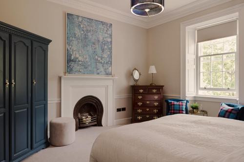 a bedroom with a bed and a fireplace at Elrick Estate - Elrick House in Newmachar