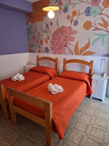 a bedroom with two beds with towels on them at Centro Ferie Salvatore in San Felice Circeo