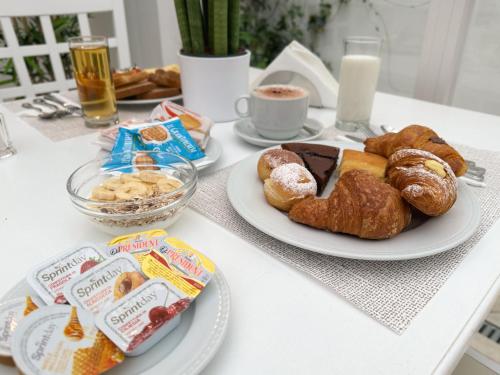 a table topped with plates of pastries and drinks at Palazzo Sant'Elena in Foggia