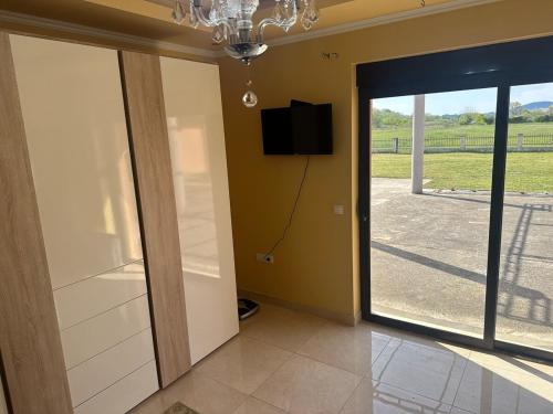 a room with a sliding glass door with a flat screen tv at Villa DeMar - Coastal luxury in Ulcinj