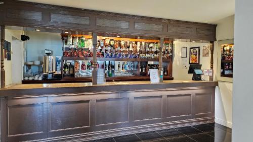 a bar with a lot of liquor bottles at The Strand Hotel in Eastbourne
