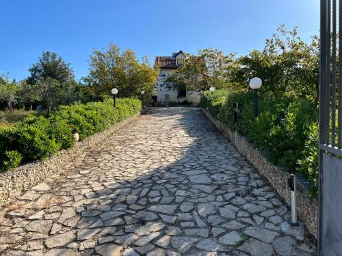 a cobblestone road with a house in the background at White House R&B in Campobello di Licata
