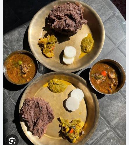 a table with three plates of food on it at Mane Dara homestay in Darjeeling