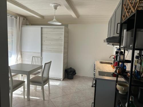 a kitchen with a table and a table and chairs at Bistro Apartman in Balatonboglár