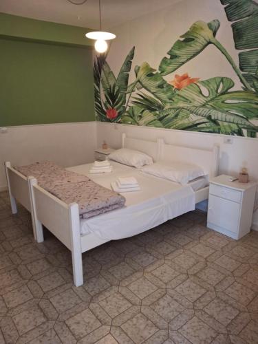 a bedroom with a bed and a painting on the wall at Centro Ferie Salvatore in San Felice Circeo