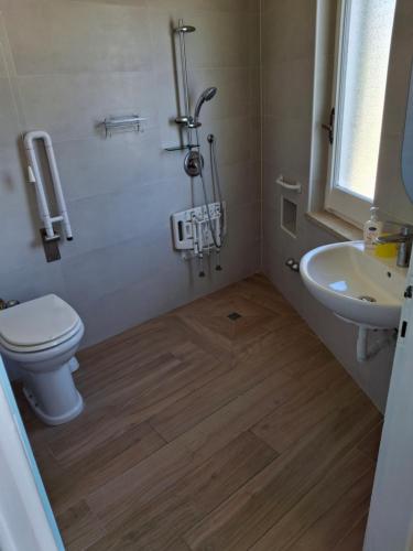 a bathroom with a toilet and a sink at Centro Ferie Salvatore in San Felice Circeo