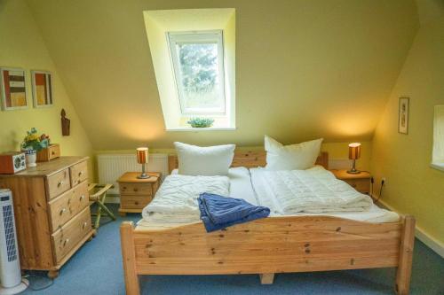 a bedroom with a large bed and a window at Landhaus Birkenhof in Varel