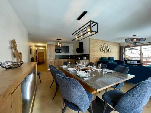 une salle à manger et un salon avec une table et des chaises dans l'établissement Homency - Residence Parenthèse A14, à L'Alpe-d'Huez