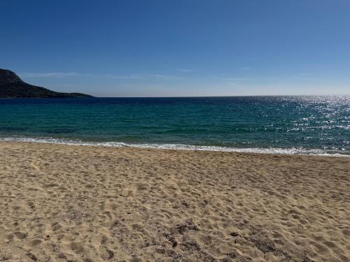 a sandy beach with the ocean in the background at Vesanos Mezonet in Toroni
