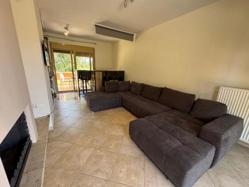 a living room with a couch and a fireplace at Vesanos Mezonet in Toroni