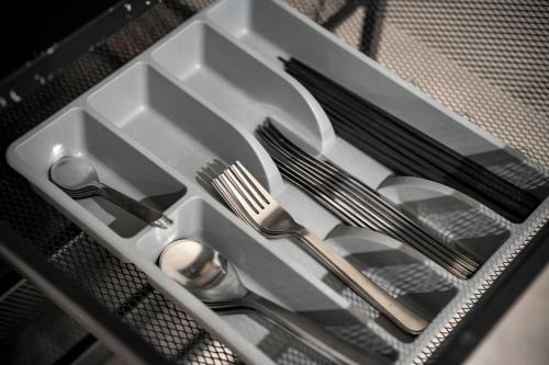 a tray with forks and spoons and utensils at Taketo Stay Kotoni 101 in Sapporo
