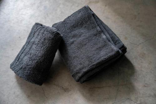 a pair of gray socks sitting on the floor at Taketo Stay Kotoni 101 in Sapporo