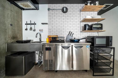 a kitchen with a stainless steel counter and a sink at Taketo Stay Kotoni 101 in Sapporo