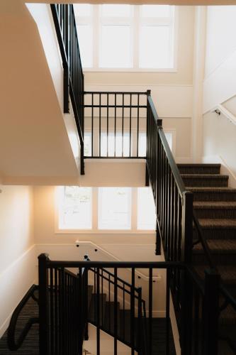 a spiral staircase in a building with a window at The Dexter by Kasa in Elk Rapids