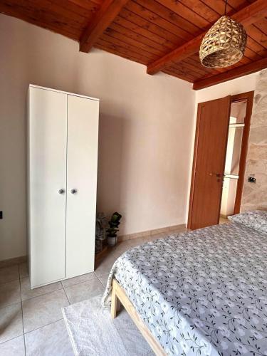 a bedroom with a bed and a white cabinet at Casa Vacanze Aurora in Coccorino