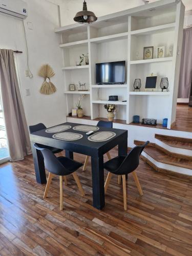 a dining room with a black table and chairs at Loft6 a solo 2 cuadras de la Costanera!!! in Corrientes