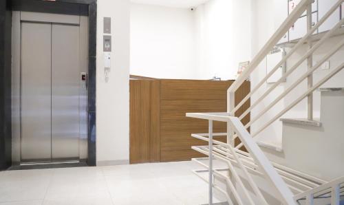a staircase leading to a door in a building at Hotel Kamron Near Airport Road Sector 78 Mohali Chandigarh in Mohali