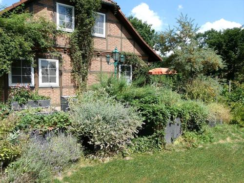 a brick house with bushes in front of it at Ferien-und Bauernhof Gauster in Trebel
