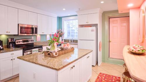 a kitchen with white cabinets and a white refrigerator at Steps From Broughton Walk To Shops And Bars-1-2 in Savannah