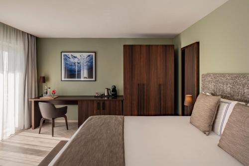 a hotel room with a bed and a desk at Waterfront in Sliema