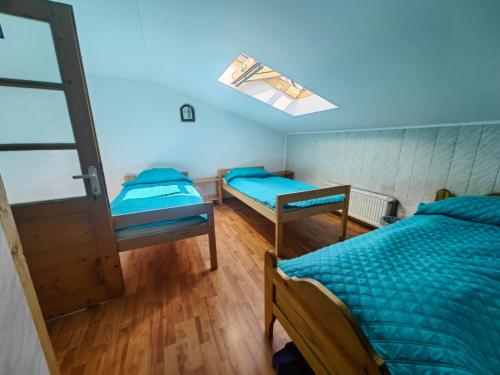 a room with two beds and a window at Casa bunicilor dor de Bucovina in Câmpulung Moldovenesc