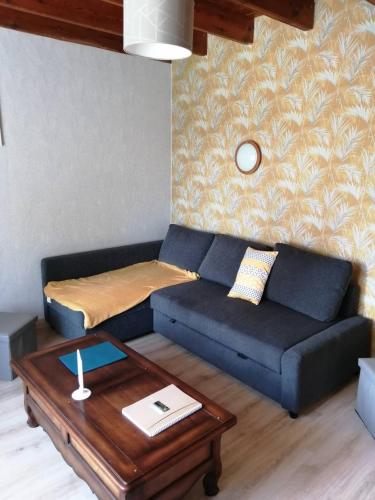 a living room with a couch and a coffee table at Maison à quelques mètres de la mer in Saint-Jean-du-Doigt