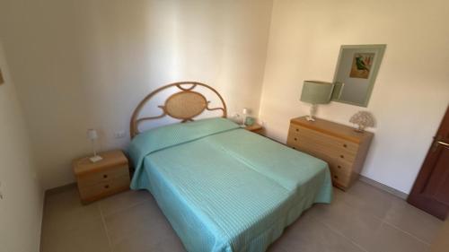 a bedroom with a bed and two night stands at Villa Ingrosso in Leporano Marina