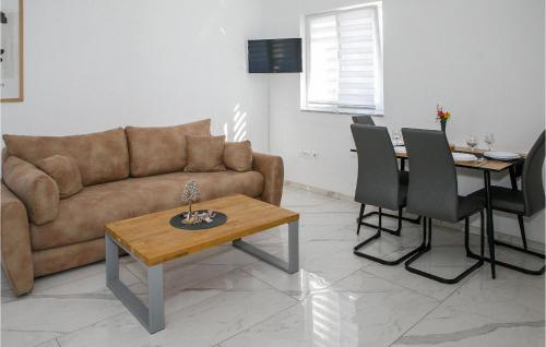 a living room with a couch and a table at 1 Bedroom Lovely Apartment In Vrsi in Vrsi