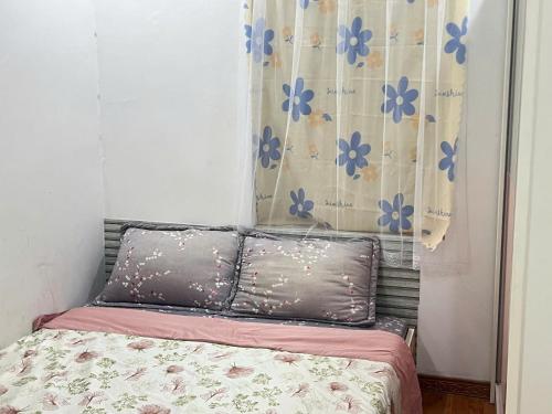 a bed with two pillows in a bedroom at Ting Ting Homestay in Hai Phong