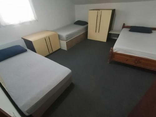 a room with three beds and twounks in it at SKOPJE Apartment in Skopje