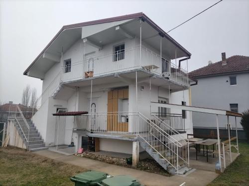 a white house with stairs and a porch at SKOPJE Apartment in Skopje
