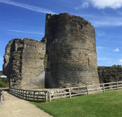 an old castle with a fence in front of it at Cilgerran - cosy cottage in Cilgerran