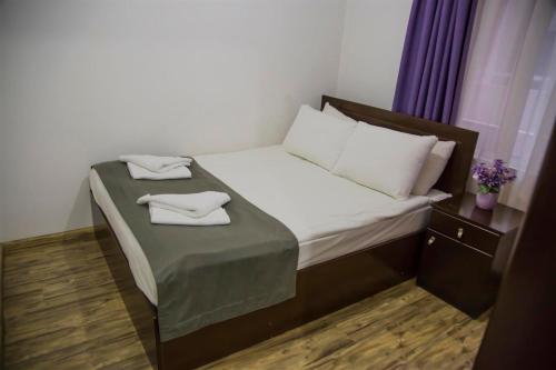 a small bed with two towels on top of it at Cyprus Apart Hotel in Mağusa