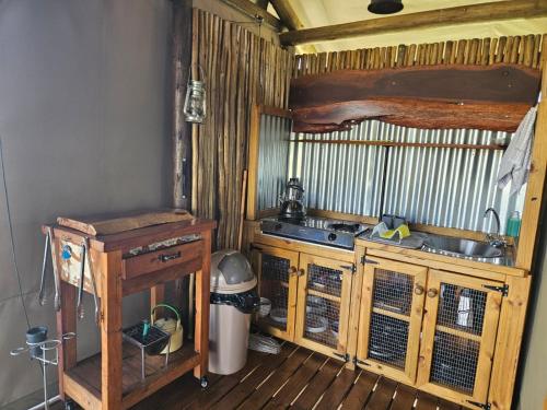 a small kitchen with a sink and a stove at Kolobe Luxury Glamping Safari Tent in Fochville