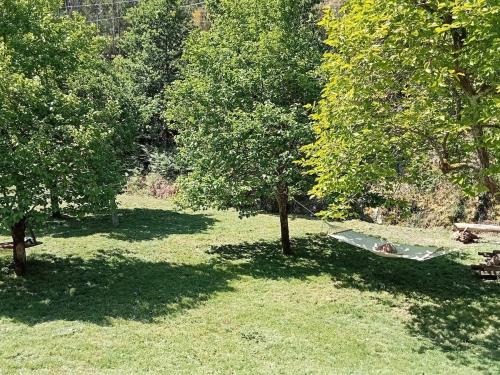a person laying in a hammock between two trees at Casa do Faval in Senande