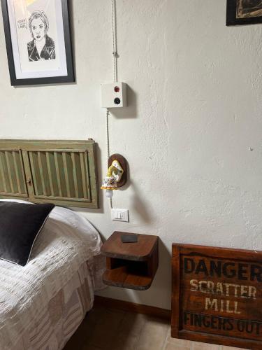 a bedroom with a bed and a nightstand next to a table at Monte Paradiso Agriturismo in Pietralunga