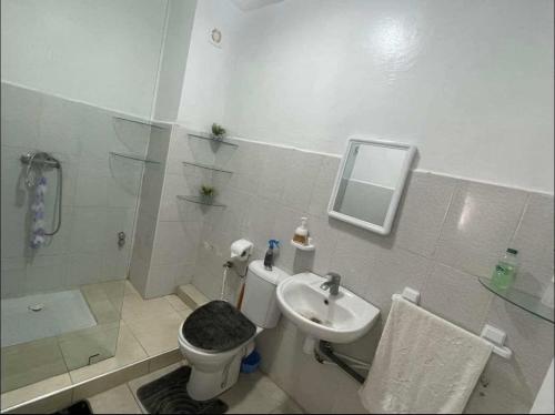a bathroom with a toilet and a sink and a shower at Confortble 2Bedroom in Downtown in El Jadida