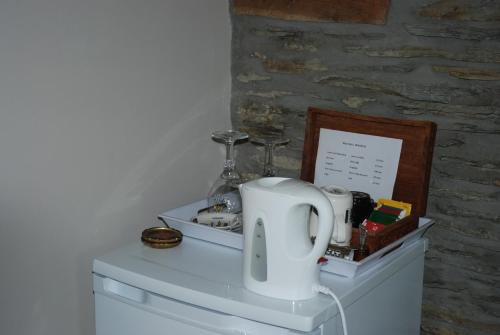 a white appliance sitting on top of a dresser at B&B Le Courtil in Dohan