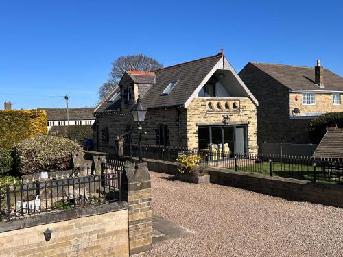 a brick house with a fence in front of it at St George’s Lodge in Halifax