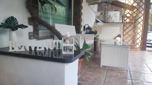 a patio with white chairs and a table with candles at Donna Rosa in Pagani