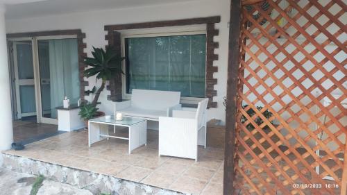 a patio with a white couch and a table at Donna Rosa in Pagani