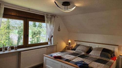 a bedroom with a bed and a large window at Ferienwohnung Pfotenglück nahe Ostsee mit atemberaubender Dachterrasse & Gartenblick in Mallentin