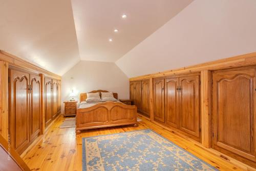 a bedroom with wooden cabinets and a bed with a blue rug at MagicLoc in Esbly