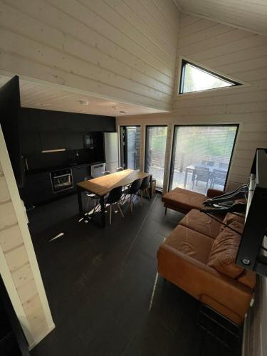 a living room with a table and a couch at Himos Siesta Porealtaalla ja loppusiivouksella in Jämsä