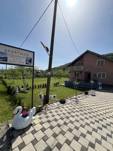 a statue of a swan sitting on a patio at Apartman Demirovic in Orašac